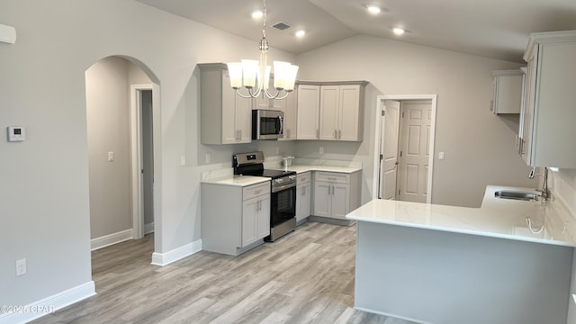 kitchen featuring a chandelier, gray cabinets, appliances with stainless steel finishes, arched walkways, and a sink