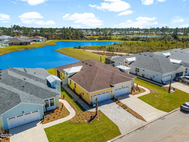 drone / aerial view with a residential view and a water view