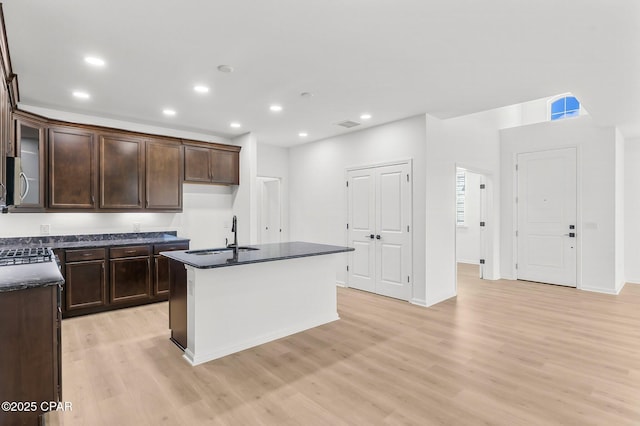 kitchen with a sink, light wood-style floors, and recessed lighting