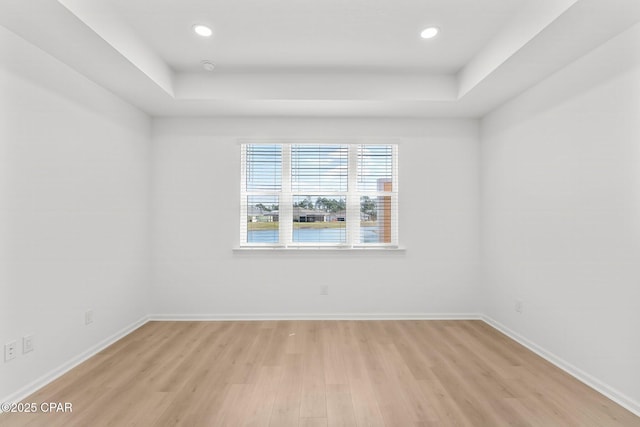 spare room with recessed lighting, light wood-style flooring, and baseboards