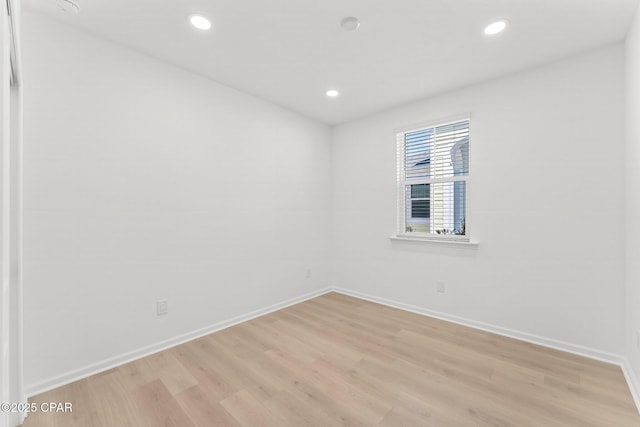 empty room featuring recessed lighting, light wood-style floors, and baseboards