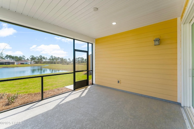 unfurnished sunroom with wood ceiling and a water view