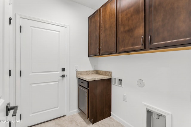 laundry room with hookup for a washing machine, cabinet space, and baseboards