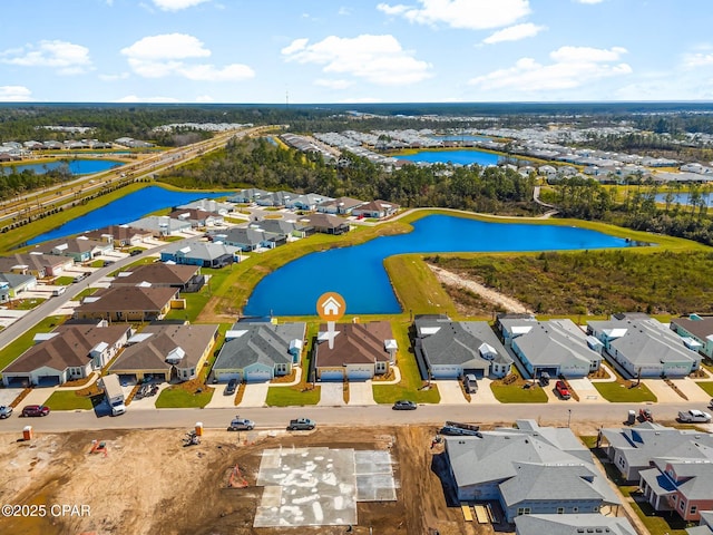 birds eye view of property featuring a water view and a residential view