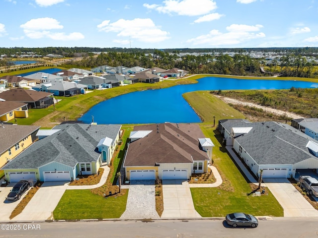 drone / aerial view with a residential view and a water view