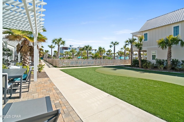 view of property's community featuring a patio area, outdoor dining space, a pergola, and fence