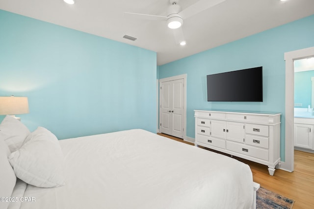 bedroom with visible vents, light wood-style flooring, recessed lighting, ceiling fan, and a closet