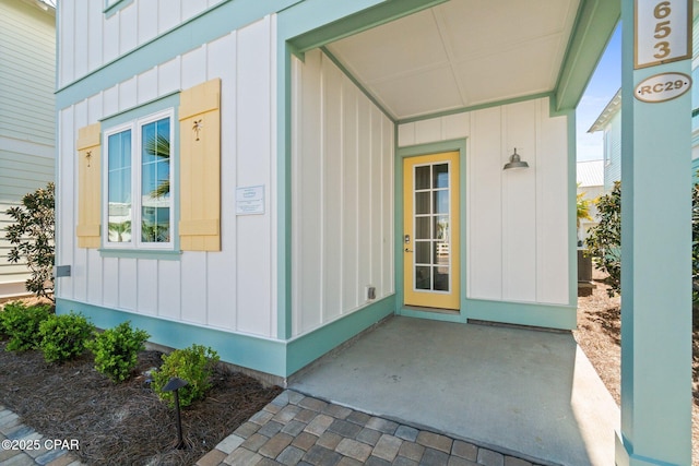 view of exterior entry with board and batten siding