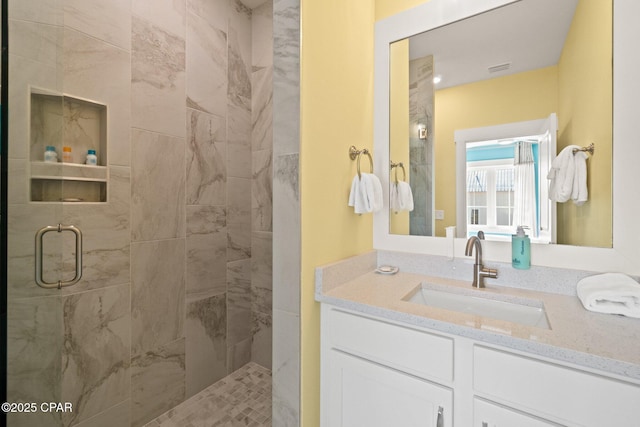 bathroom featuring vanity and a shower stall