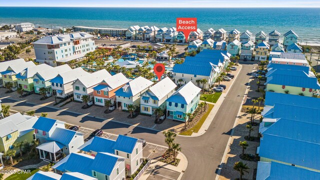 drone / aerial view featuring a residential view and a water view