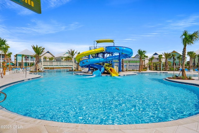 pool with playground community and a water slide