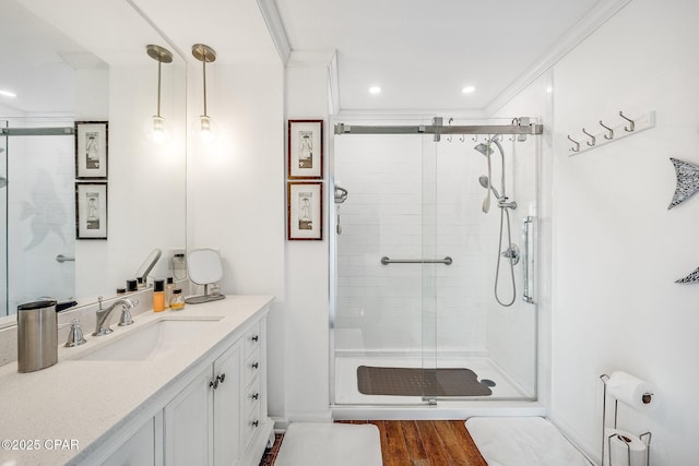 full bath with crown molding, recessed lighting, a stall shower, wood finished floors, and vanity