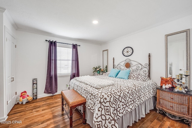 bedroom featuring wood finished floors, baseboards, and ornamental molding