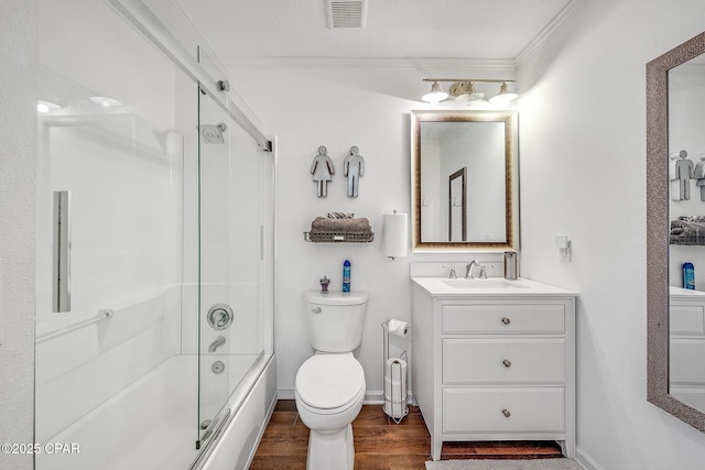 full bathroom featuring vanity, wood finished floors, visible vents, shower / bath combination with glass door, and toilet