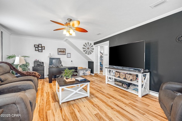 living room featuring crown molding, wood finished floors, and visible vents