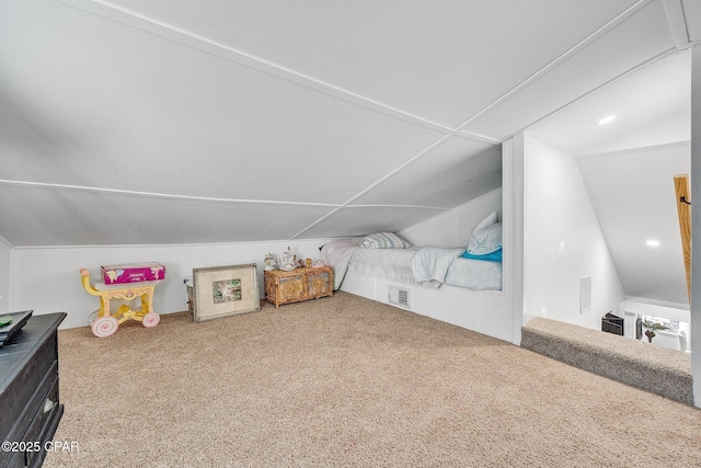 additional living space featuring lofted ceiling, visible vents, and carpet floors