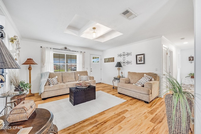 living room with visible vents, ornamental molding, a skylight, and wood finished floors