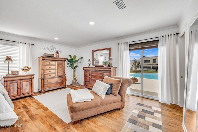 sitting room featuring crown molding, recessed lighting, light wood-style floors, and visible vents