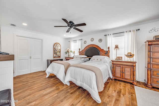 bedroom with crown molding, light wood-style flooring, recessed lighting, and a ceiling fan