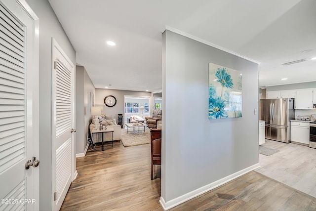 corridor featuring visible vents, recessed lighting, light wood-type flooring, and baseboards