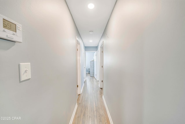 hallway with baseboards and light wood-type flooring