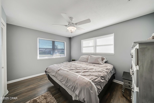 bedroom featuring dark wood-style floors, baseboards, and ceiling fan