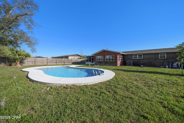 view of swimming pool featuring a fenced backyard, a fenced in pool, cooling unit, and a yard