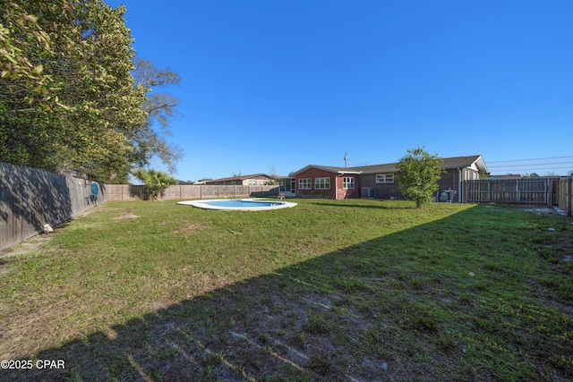 view of yard with a fenced in pool and a fenced backyard