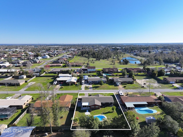 drone / aerial view featuring a residential view and a water view