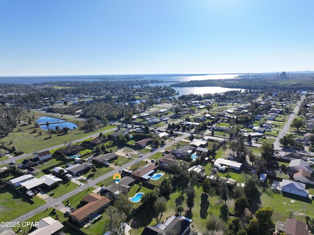 drone / aerial view featuring a residential view and a water view