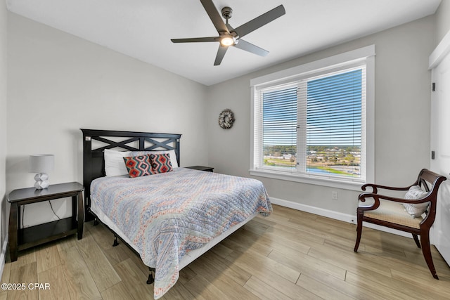 bedroom featuring a ceiling fan, wood finished floors, and baseboards