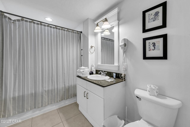 full bath featuring toilet, shower / bath combo, vanity, and tile patterned flooring