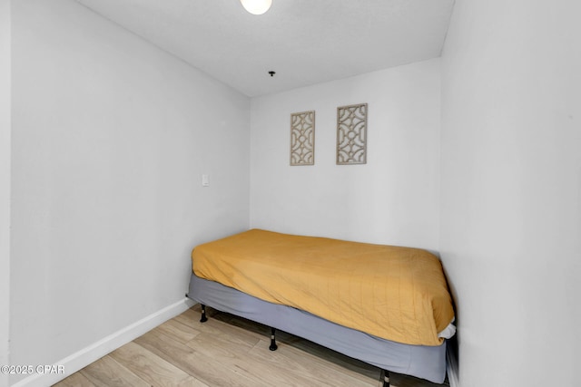 bedroom with baseboards and light wood-style floors