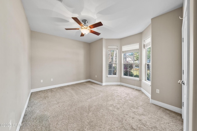 unfurnished room featuring carpet flooring, baseboards, and ceiling fan