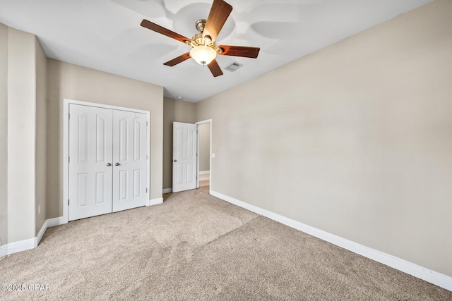 unfurnished bedroom with a ceiling fan, baseboards, visible vents, a closet, and carpet flooring