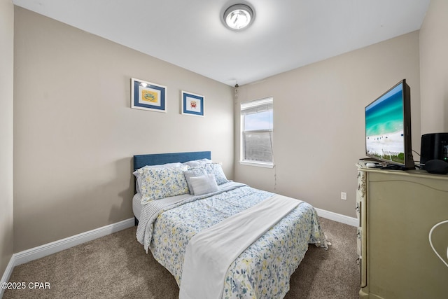 bedroom with baseboards and carpet