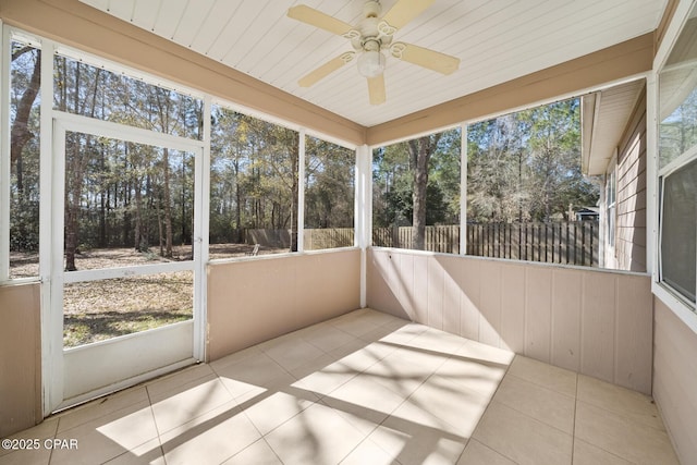 unfurnished sunroom with ceiling fan