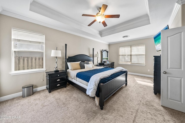 bedroom with crown molding, a raised ceiling, and baseboards