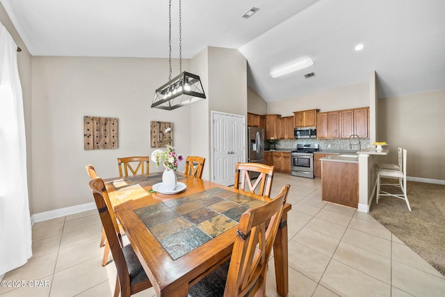 dining room featuring light tile patterned floors, baseboards, and visible vents