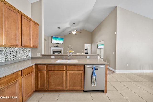 kitchen with a sink, brown cabinets, dishwasher, and a peninsula