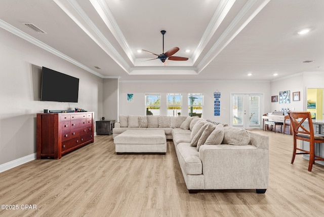 living area with ceiling fan, ornamental molding, recessed lighting, light wood-style floors, and a raised ceiling