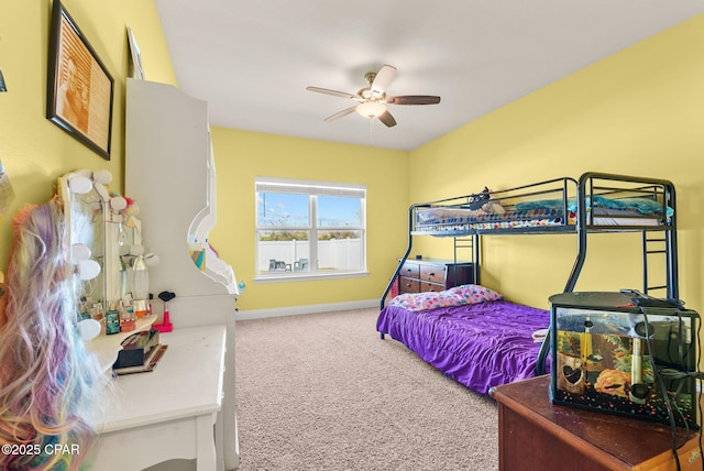 carpeted bedroom featuring baseboards and a ceiling fan