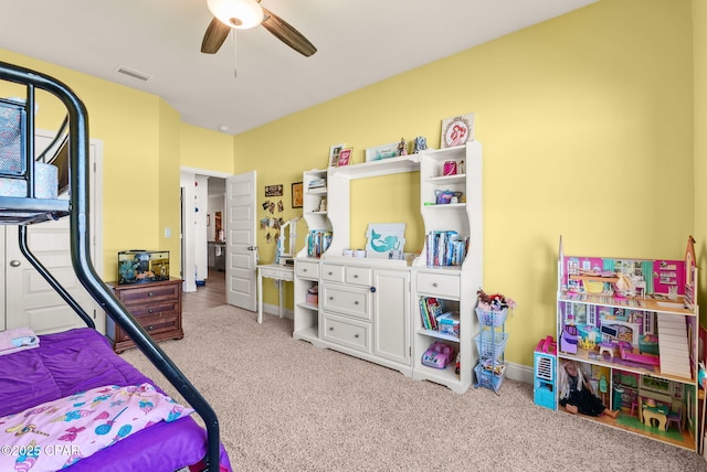 carpeted bedroom featuring a ceiling fan, visible vents, and baseboards