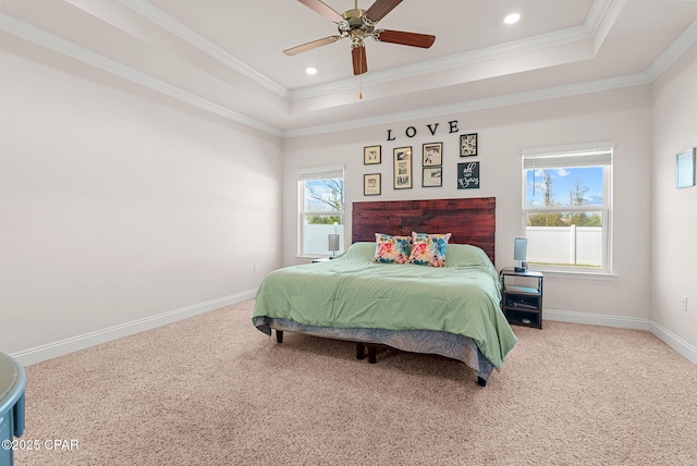 bedroom with a tray ceiling, carpet, baseboards, and ornamental molding