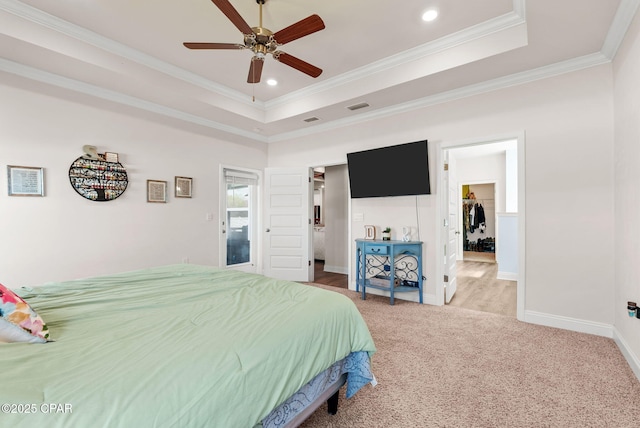 bedroom with visible vents, carpet, a tray ceiling, and ornamental molding