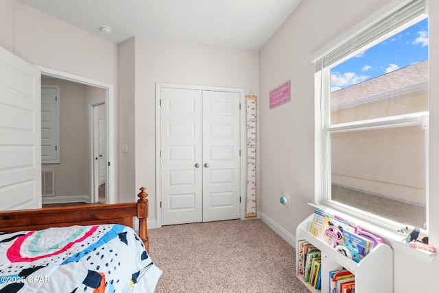 bedroom with visible vents, a closet, carpet floors, and baseboards