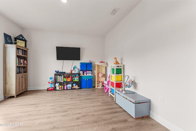 game room featuring wood finished floors, visible vents, and baseboards