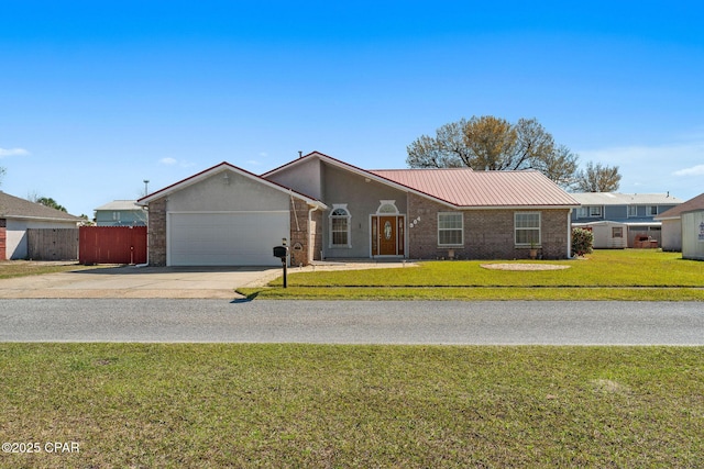 view of front of house with fence, concrete driveway, a front lawn, a garage, and metal roof