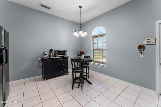 dining room featuring light tile patterned floors, visible vents, a toaster, and baseboards