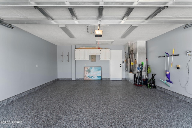 garage with a garage door opener and baseboards